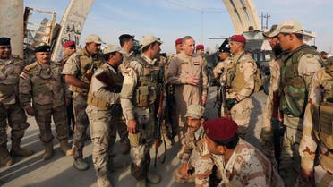 Iraqi Defense Minister Khalid al-Obeidi, center, speaks to his soldiers after a military operation to regain control of the university of Tikrit, 130 kilometers north of Baghdad, Iraq in 2014. (File photo: AP)