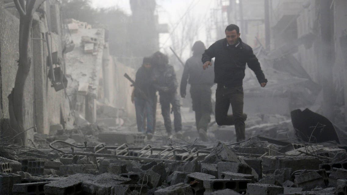 3. Free Syrian Army fighters try to evacuate a damaged area fearing another air strike after what activists said were air strikes by forces loyal to Syria's President Bashar al-Assad in Marj Al Sultan, in the eastern Damascus suburb of Ghouta February 27, 2015. (Reuters)
