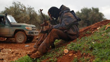 A rebel fighter of al-Jabha al-Shamiya (the Shamiya Front) covered with mud carries his weapon as he sits near the front line with Bashkuwi village, north of Aleppo February 19, 2015. (Reuters)