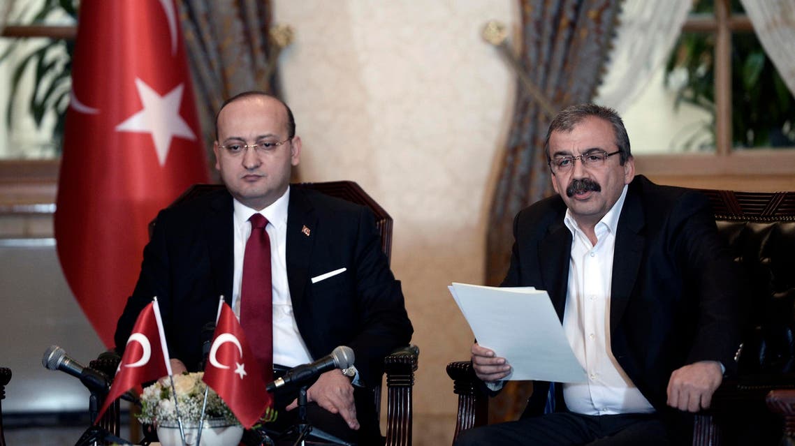 Sirri Sureyya Onder, a lawmaker of the pro-Kurdish Peoples' Democratic Party (HDP), reads a statement during a meeting with Turkey's Deputy Prime Minister Yalcin Akdogan (L) in Istanbul February 28, 2015. (Reuters)