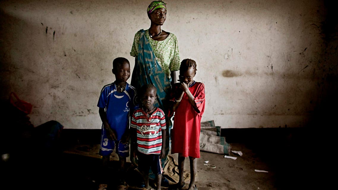 In this Wednesday, April 6, 2011 photo, a mother and her children who recently fled heavy fighting stand inside a schoolroom that has been transformed into a makeshift camp for displaced persons in the town of Khorfulus, Jonglei state, Southern Sudan. (File photo: AP)