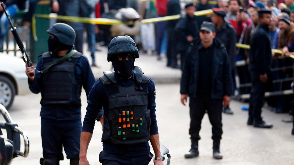 Members of the police special forces take up position and guard the scene of a car bomb blast in front of The High Court in downtown Cairo, March 2, 2015. (Reuters)
