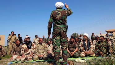 Shi'ite cleric Ahmed al-Rubaei (C) speaks with Iraqi soldiers and Shiite fighters in Udhaim dam, north of Baghdad March 1, 2015. (Reuters)