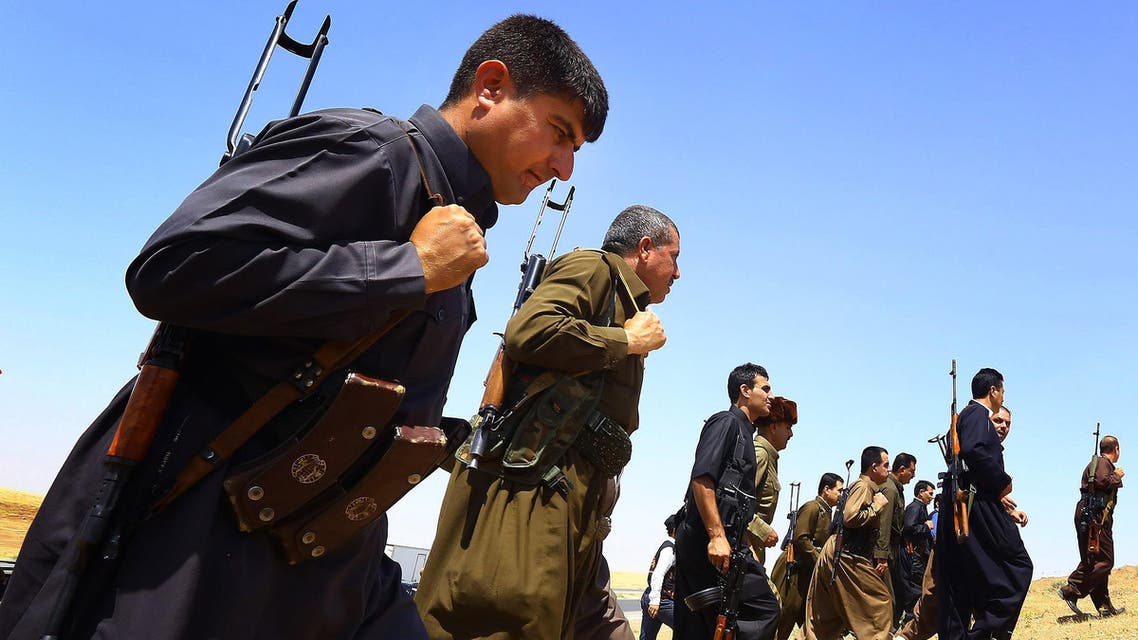 in this Saturday, June 14, 2014 file photo, Kurdish Peshmerga security forces stand guard on the outskirts of the northern city of Mosul, Iraq.