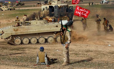 Shi'ite fighters sit in front of a tank during deployments in the town of Hamrin in Salahuddin province March 3, 2015. (Reuters)