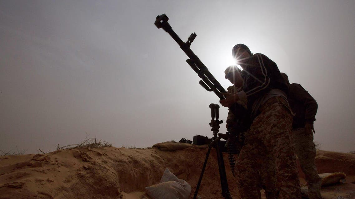 In this Saturday, Feb. 21, 2015 photo, Libyan soldiers try to fix a weapon that jammed during clashes with militants on the frontline in Al Ajaylat, west of Tripoli, Libya. (AP)