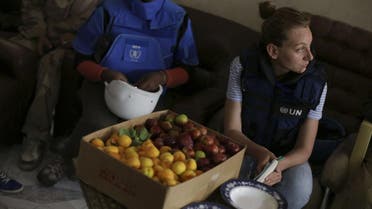 United Nations and World Food program members sit beside a box of fruits in eastern Ghouta of Damascus. (File Photo: Reuters)