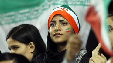 Iranian young woman fans watch their team winning during their 2014 World Cup Asian zone qualifying football match between Qatar and Iran at the Al-Sadd stadium in Doha on, Tuesday,June, 4, 2013. (AP)