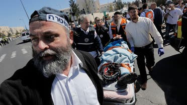 An Israeli policeman and medics evacuate an injured person at the scene of an attack in Jerusalem March 6, 2015. (Reuters)