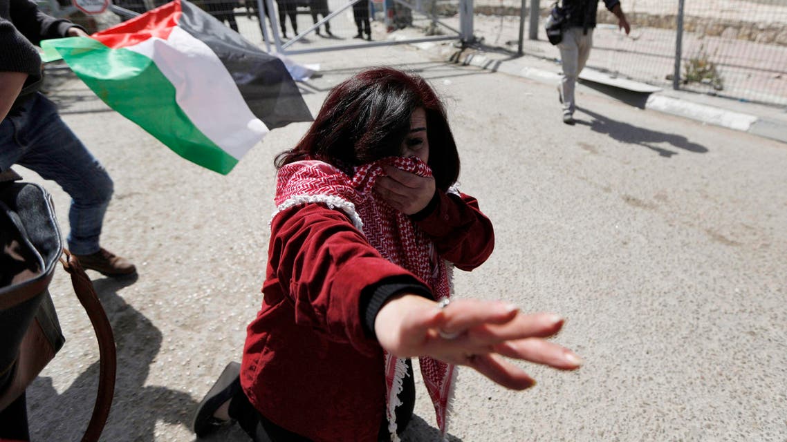  A Palestinian woman reacts after Israeli border policemen used pepper spray to disperse a rally ahead of International Woman's Day, at Qalandiya checkpoint near the West Bank city of Ramallah March 7, 2015. (Reuters)