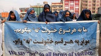 Afghan men wear burqas in Kabul to mark International Women's Day