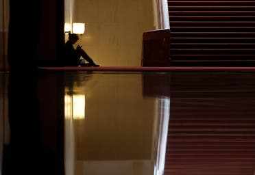 A woman sits inside the Great Hall of the People during the opening session of the Chinese People's Political Consultative Conference (CPPCC) in Beijing, March 3, 2015. (File photo: Reuters)