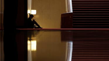 A woman sits inside the Great Hall of the People during the opening session of the Chinese People's Political Consultative Conference (CPPCC) in Beijing, March 3, 2015. (File photo: Reuters)