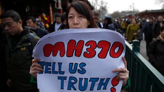Chinese MH370 relatives mark anniversary under police gaze 