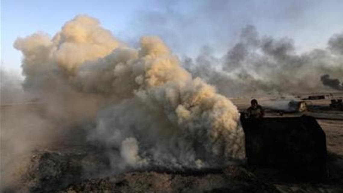 A man works at a makeshift oil refinery site in al-Mansoura village in Raqqa's countryside May 5, 2013. Reuters