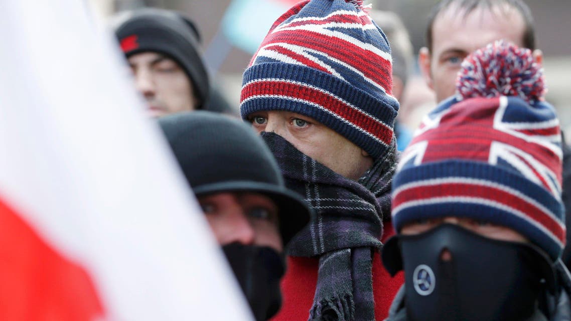 Men with their faces covered attend a demonstration by supporters of the Pegida movement in Newcastle, northern England, February 28, 2015.