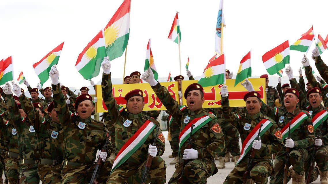 Iraqi Christian forces gesture during their graduation ceremony in the northwestern town of Fishkhabur, near the borders with Syria and Turkey, on March 12, 2015. (AFP)