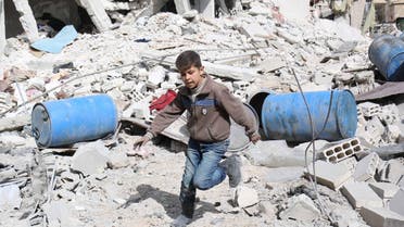 A boy runs over rubble at a site hit on Tuesday by what activists said were airstrikes by forces loyal to Syria's President Bashar al-Assad in the rebel-controlled area near Damascus March 11, 2015.  (Reuters)