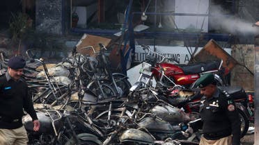 Policemen inspect damaged motorcyles at the site of an explosion outside police headquarters, in Lahore February 17, 2015. (Reuters)