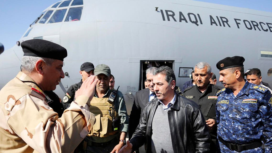 Iraqi Interior Minister Mohammed Salem al-Ghabban (C) arrives at the Ain Al-Asad military base in the Anbar province, after accompanying refugees from the town of al-Baghdadi, Feb. 26, 2015. (Reuters)