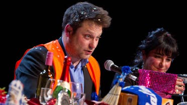 Yassin Musharbash of German weekly 'Die Zeit' reads from a letter-to-the-editor during the 'Hate Poetry' show in the Theaterlabor in Bielefeld, Germany. (AP)