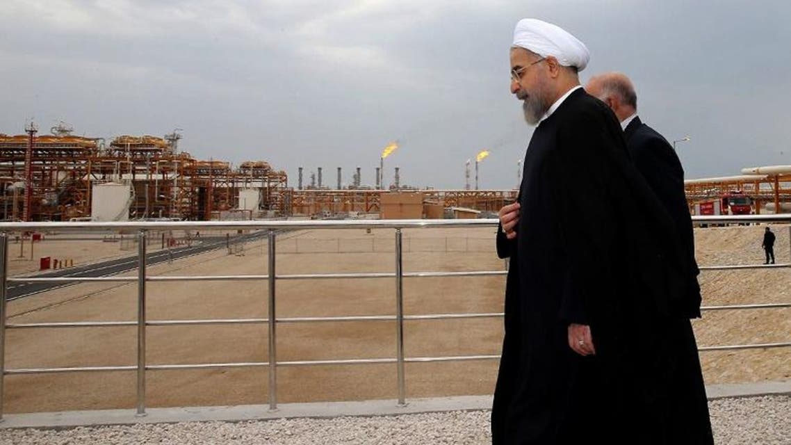 Iranian President Hassan Rouhani shows him (L) walking with Oil Minister Bijan Namdar Zanaganeh (R) at phase 12 of the South Pars gas field facilities in the southern Iranian port of Assaluyeh. (AFP)