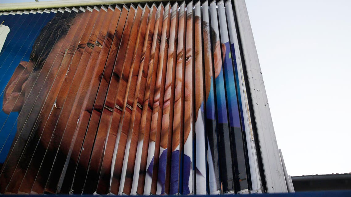 Israel's Prime Minister Benjamin Netanyahu (R) and Isaac Herzog, co-leader of the centre-left Zionist Union, are pictured together as campaign billboards rotate in Tel Aviv March 15, 2015.