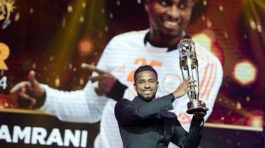 Saudi Arabia Al Hilal striker Nassir Al Shamrani raises the trophy after winning the Asian Football Confederation (AFC) Player of the Year. (AFP)