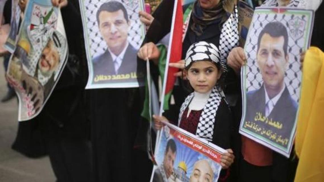 Palestinian supporters of former head of Fatah in Gaza, Mohammed Dahlan, hold posters depicting Dahlan (R) during a protest against Palestinian President Mahmoud Abbas in Gaza City December 18, 2014. (Reuters)