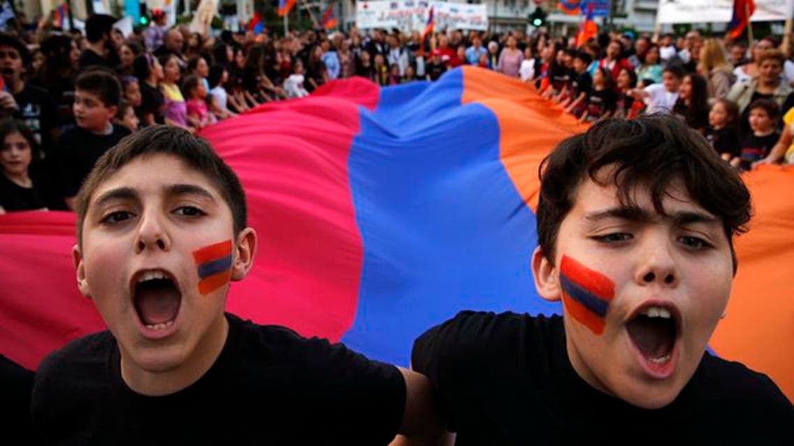 Armenian boys shout slogans against Turkey in front of a huge Armenian flag during a demonstration near the Turkish embassy in central Athens, April 24, 2013. (File: Reuters)
