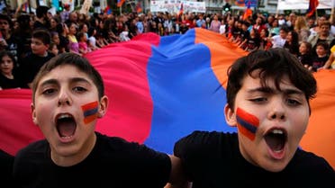 Armenian boys shout slogans against Turkey in front of a huge Armenian flag during a demonstration near the Turkish embassy in central Athens, April 24, 2013. (File: Reuters)