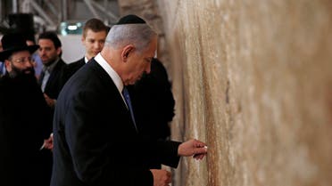 Israel's Prime Minister Benjamin Netanyahu places a note in the Western Wall, Judaism's holiest prayer site, in Jerusalem's Old City March 18, 2015. (Reuters)