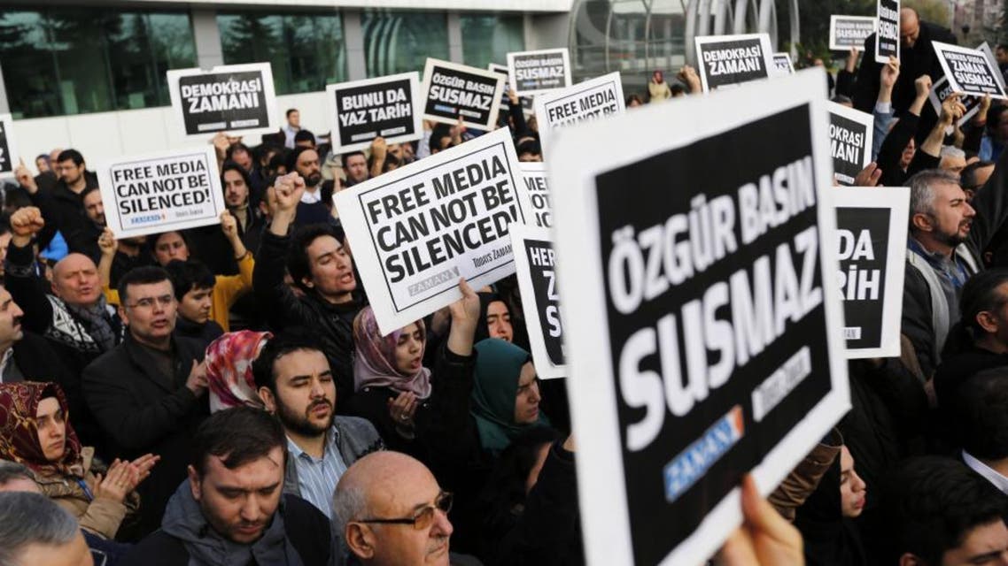 Zaman media group employees hold banners outside the headquarters of Zaman daily newspaper in Istanbul December 14, 2014. (Reuters)