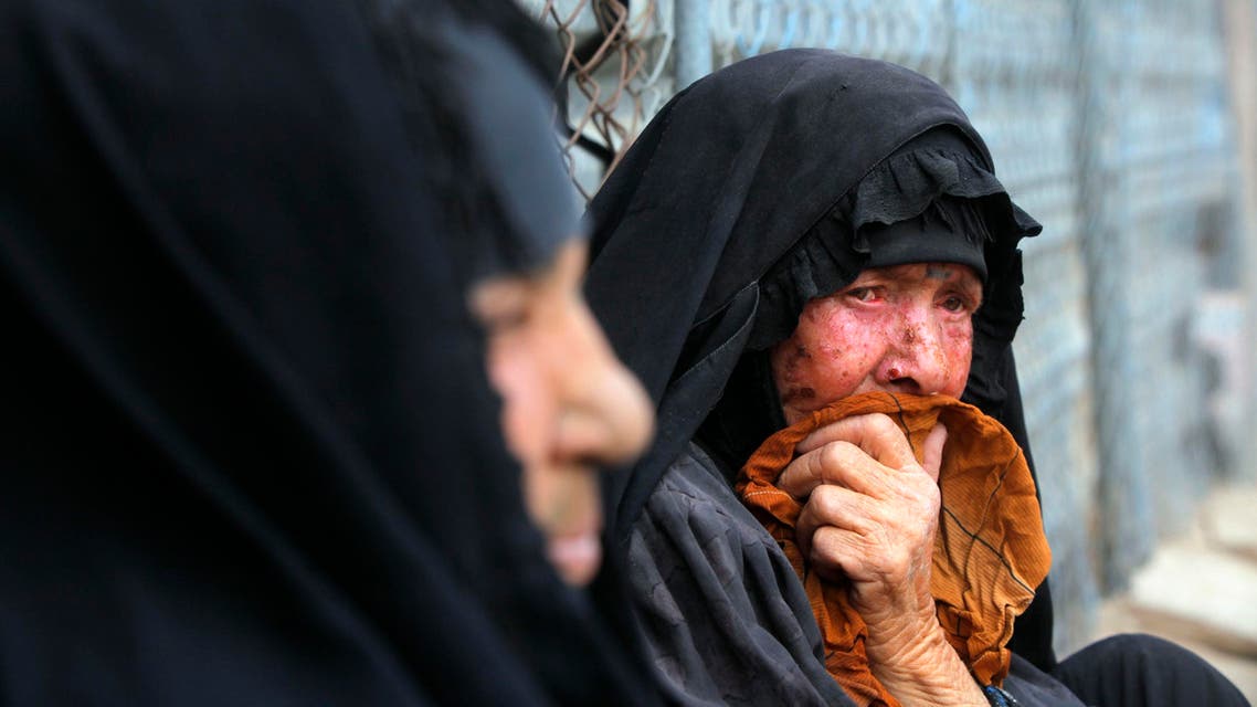 Displaced women sit outside of their tent at Camp Habbaniyah between the cities of Fallujah and Ramadi, March 12, 2015. (Reuters)