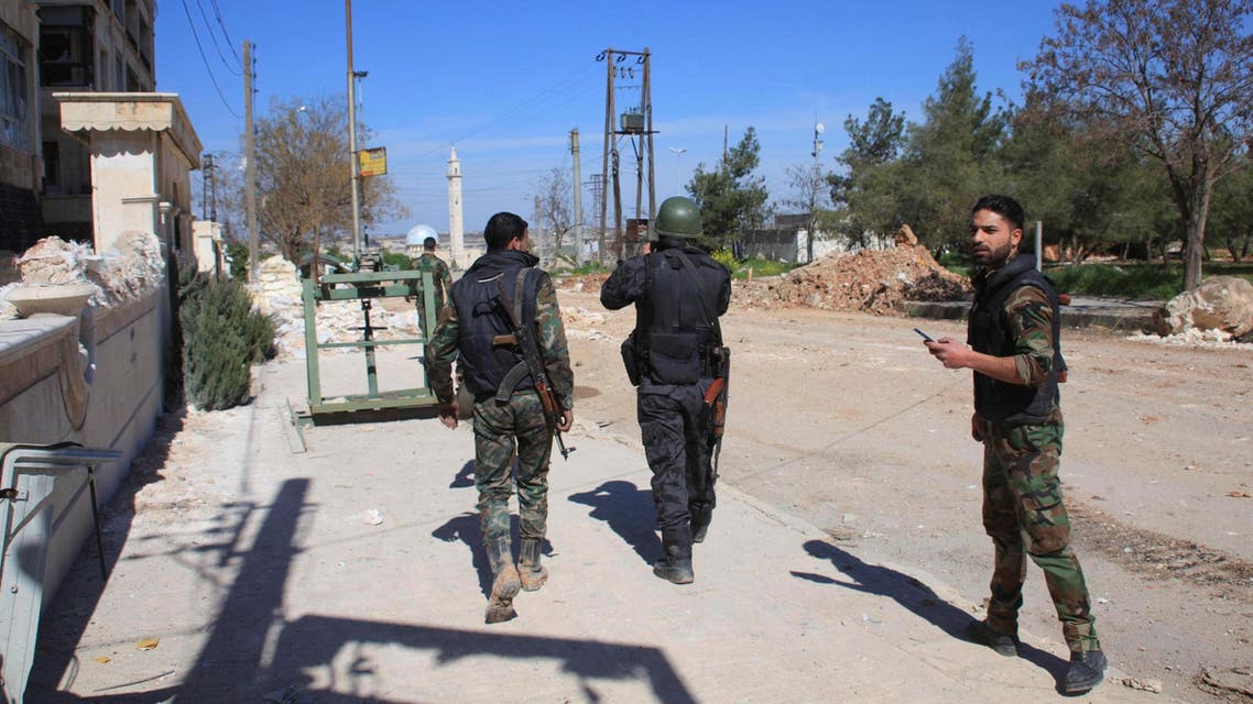 Forces loyal to Syria's President Bashar al-Assad walk along a street near the Syrian government Air Force Intelligence building (unseen) that came under attack by insurgents on Wednesday and part of it had been destroyed, in the northern city of Aleppo March 5, 2015. (Reuters)