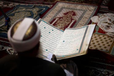 An elderly man reads verses of the Quran, Islam's holy book, in the old city of Sanaa, Yemen, July 10, 2013. (AP)