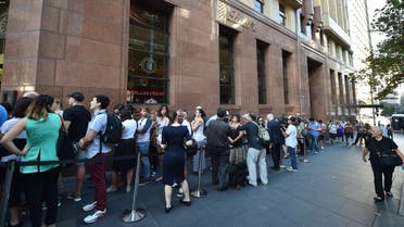 Members of the public queue outside the Lindt Cafe at Martin Place in Sydney ahead of the re-opening on March 20, 2015. AFP