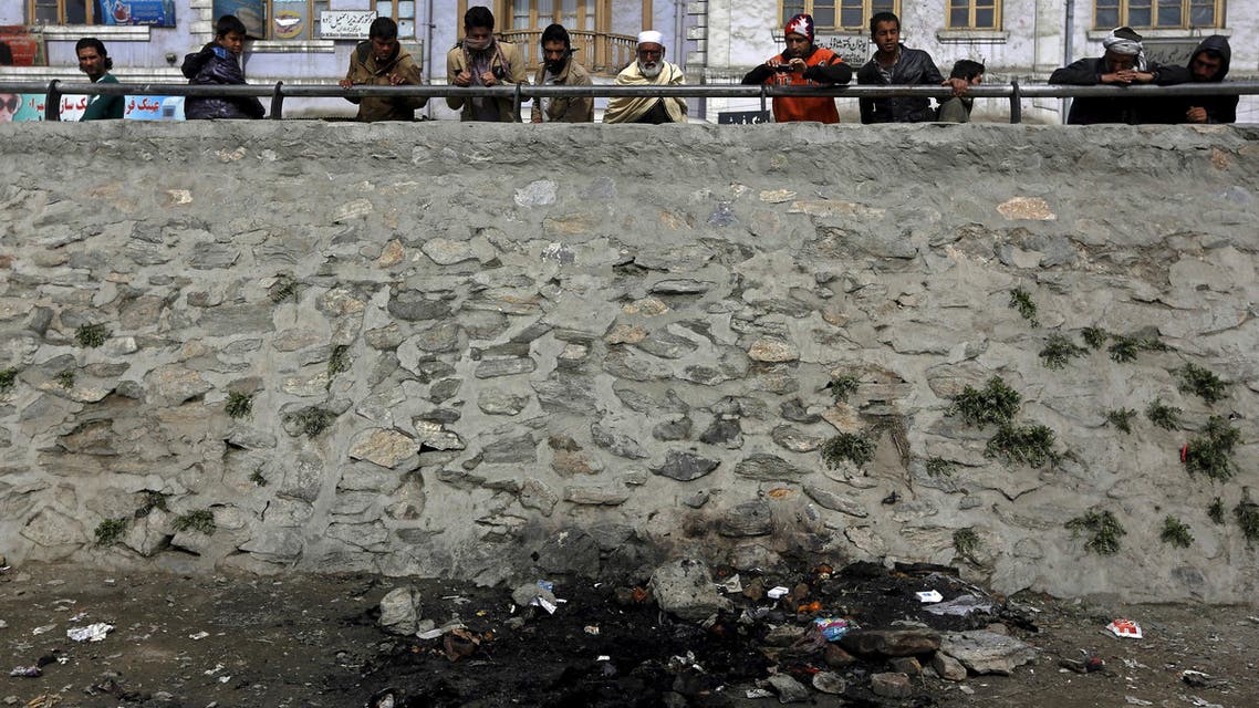 Afghan men look at the site where an Afghan woman was beaten to death and her body set on fire in Kabul, March 20, 2015. (Reuters)