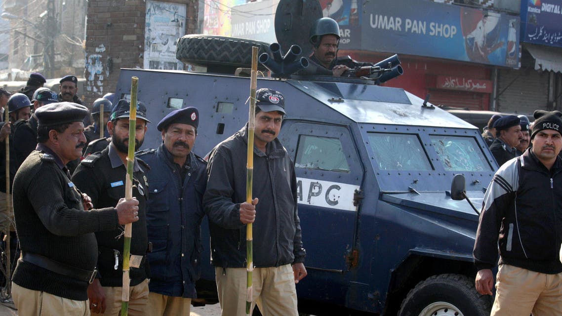 Pakistani police officers stand guard close to the venue of a mass funeral service of the victims of Sunday's pair of suicide attacks on two churches in Lahore, Pakistan, Tuesday, March 17, 2015. (AP)