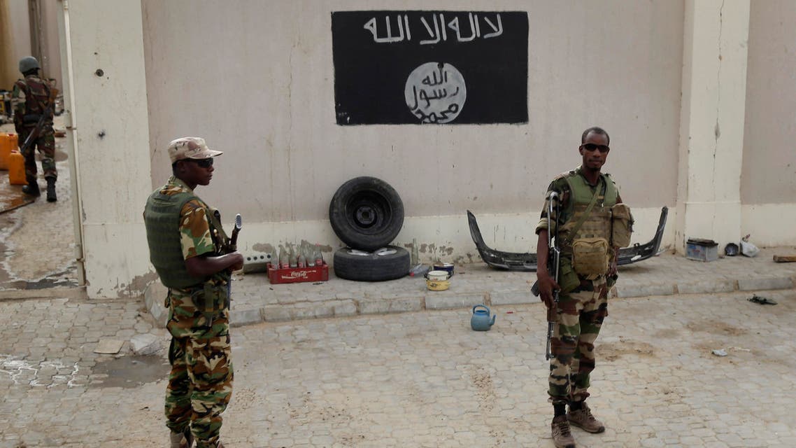 Chadian soldiers stand at a checkpoint in front of a Boko Haram flag the Nigerian city of Damasak, Nigeria, Wednesday March 18, 2015. Damasak was flushed of Boko Haram militants last week, and is now controlled by a joint Chadian and Nigerien force. (AP)