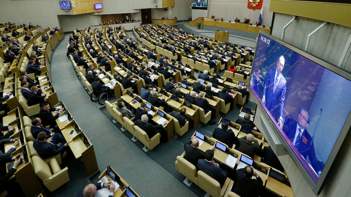Members of the State Duma, lower parliament chamber, listen to Russian Foreign Minister Sergey Lavrov, seen on the screen, prior to voting during a plenary session in Moscow, Russia, Thursday, March 20, 2014. (AP)