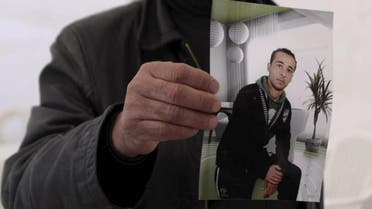 The cousin of Yassine al-Abidi, who gunned down 20 foreign tourists at Tunisia's Bardo museum, shows a photo of Yassine during an interview with Reuters in Tunis March 20, 2015. (Reuters)