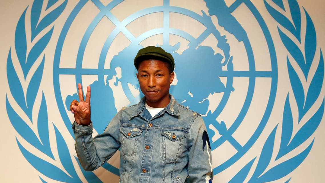 Musician Pharrell Williams (R) and Philippe Cousteau during the International Day of Happiness. (AP)