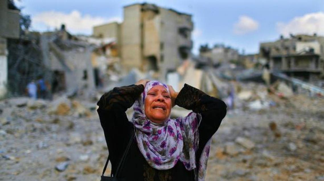  A Palestinian woman in front of her decimated home in the Gaza town of Beit Hanoun. (Reuters) 