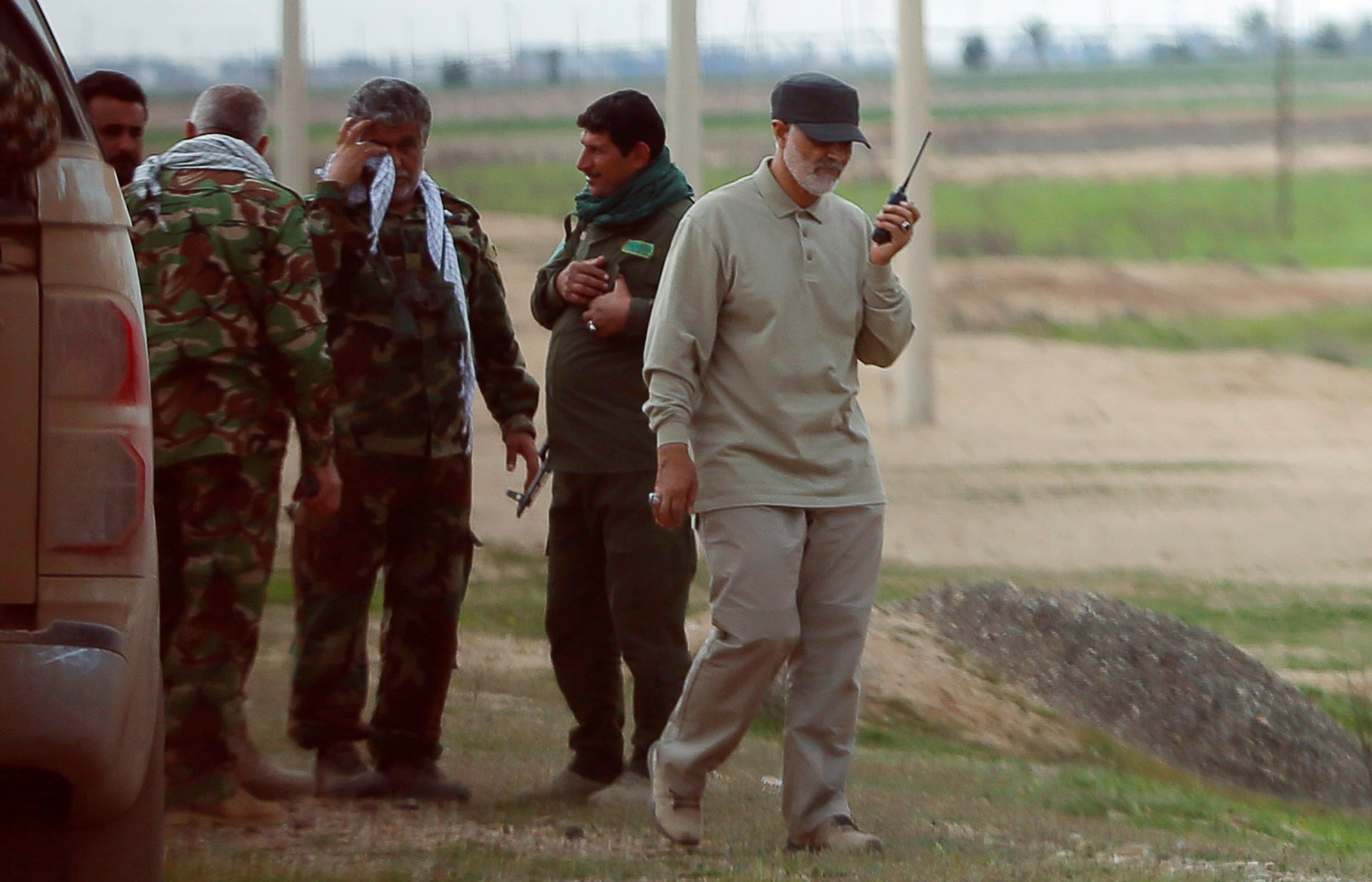 Iranian Revolutionary Guard Commander Qassem Soleimani uses a walkie-talkie at the frontline during offensive operations against ISIS militants in Salahuddin province March 8, 2015. (Reuters) 