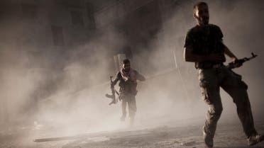  In this Friday, Sept 7, 2012 file photo, free Syrian Army fighters run after attacking a Syrian Army tank during fighting in the Izaa district in Aleppo, Syria. (AP)