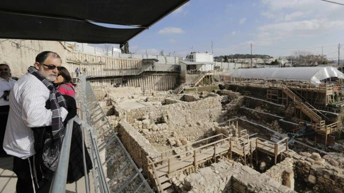 A visitor looks at the archaeological site known as the City of David, situated just outside the Old City in East Jerusalem January 23, 2014. (Reuters/Ammar Awad)