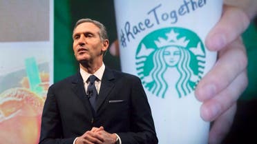 Starbucks Corp Chief Executive Howard Schultz, pictured with images from the company's new "Race Together" project behind him, speaks during the company's annual shareholder's meeting in Seattle, Washington March 18, 2015. (Reuters)
