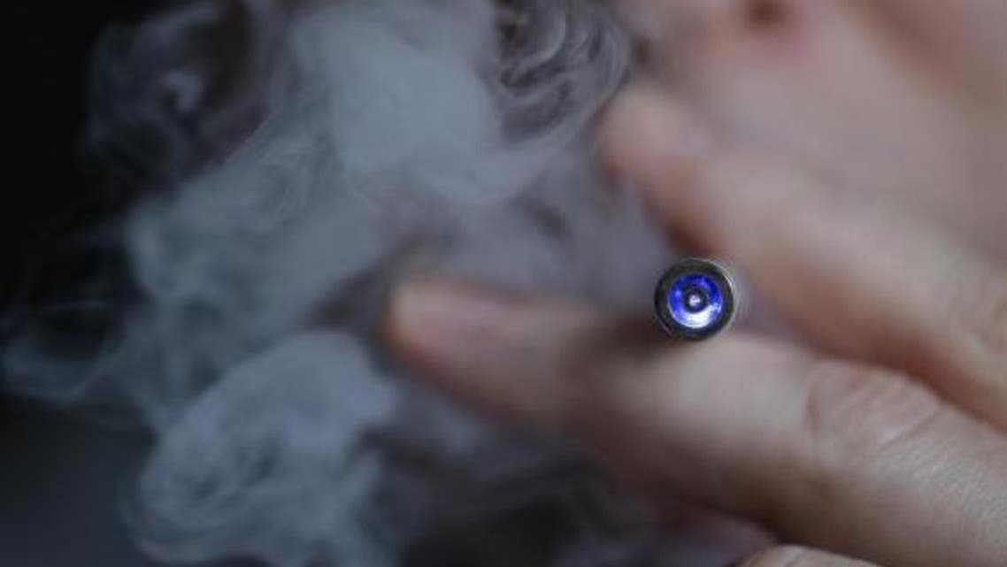A man uses an E-cigarette, an electronic substitute in the form of a rod, slightly longer than a normal cigarette, in this March 5, 2013 file illustration picture taken in Paris. (Reuters)