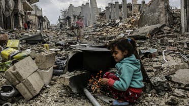 Kurdish Syrian girls are pictured among destroyed buildings in the Syrian Kurdish town of Kobane, also known as Ain al-Arab, on March 22, 2015. AFP 
